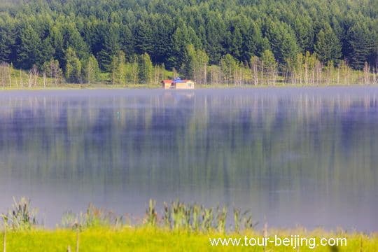 The surface of the quiet lake resembles a huge mirror with multi-color reflections