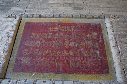 Ironically on the stone plaque brushed with the words quoted from Mao Zedong.
