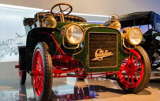 The old time care has an exaggerated headlights and thin tires.