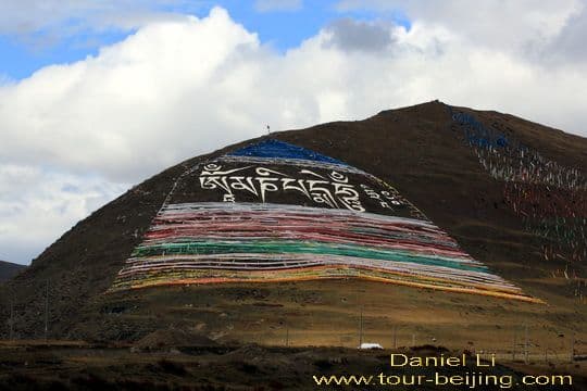 a huge mantra painted on the slope