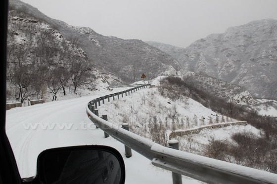 We drive along zigzag mountain road and pass two mountains before we reach Changyucheng Village